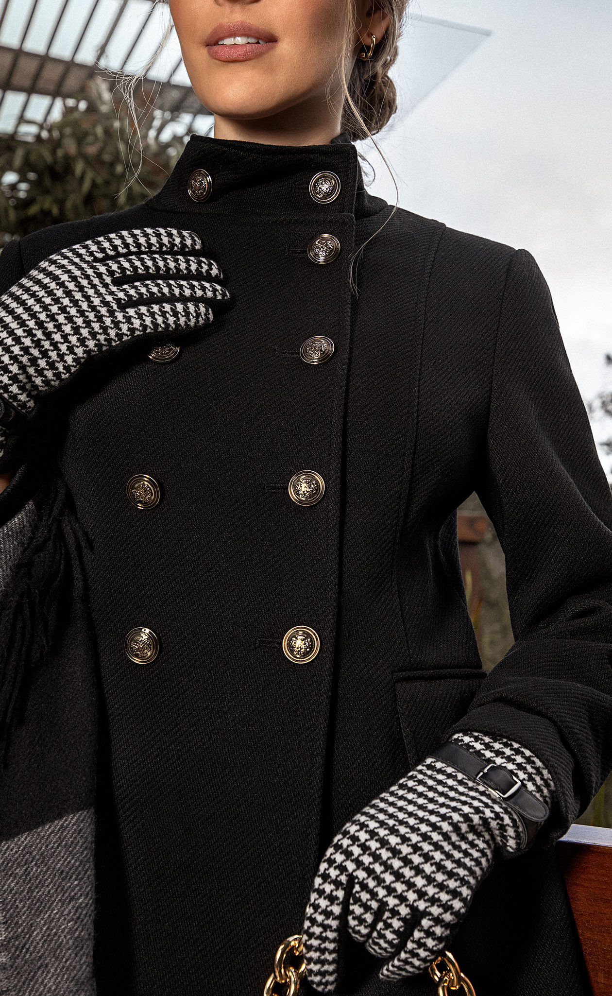Foto de mujer usando gabán negro cuello alto con 10 botones y guantes en pu para el frío con tela gallineto y herrajes 